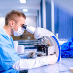 Scientist working in chemistry laboratory, examining samples at Scientist working in chemistry laboratory, examining samples at microscop